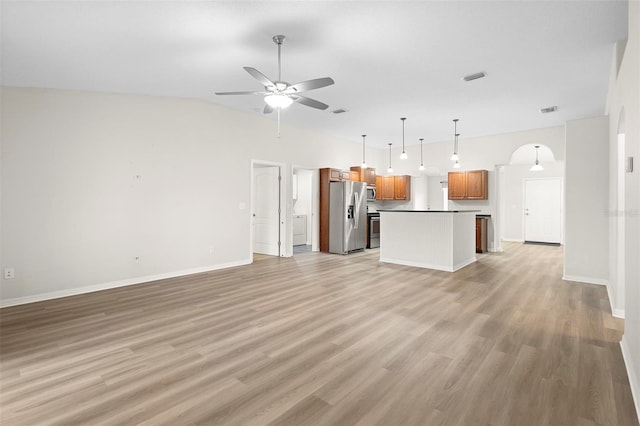 unfurnished living room featuring ceiling fan and light wood-type flooring