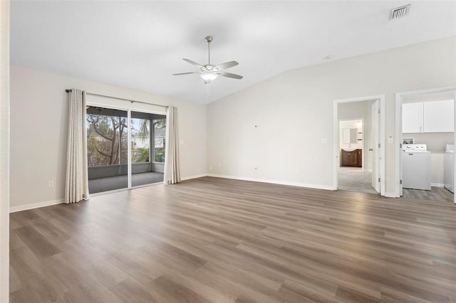 unfurnished room featuring lofted ceiling, hardwood / wood-style floors, washer and clothes dryer, and ceiling fan