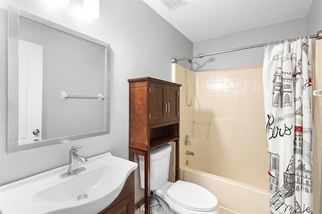 full bathroom with vanity, toilet, shower / tub combo, and a textured ceiling