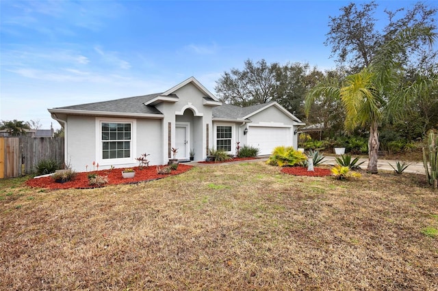 ranch-style home with a garage and a front yard