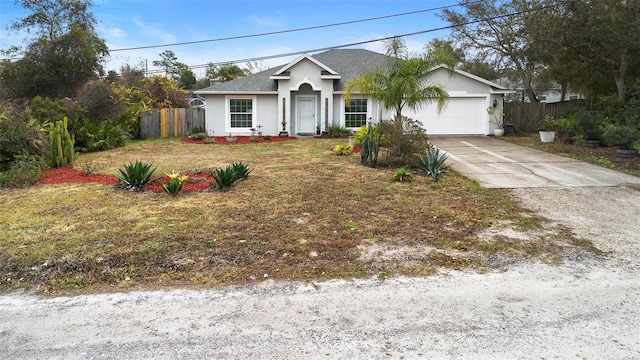 single story home with a garage and a front yard