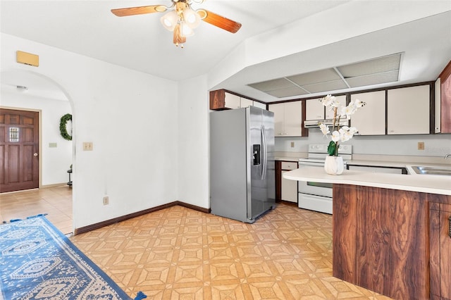 kitchen with sink, white cabinetry, stainless steel fridge with ice dispenser, ceiling fan, and white range with electric cooktop