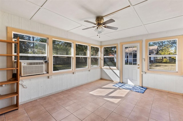 unfurnished sunroom with cooling unit and ceiling fan