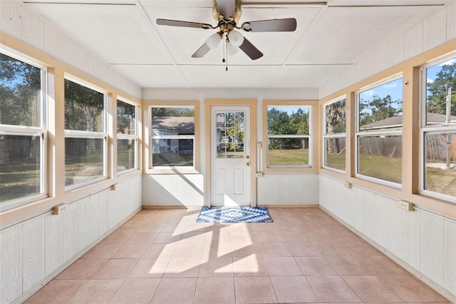 unfurnished sunroom with ceiling fan