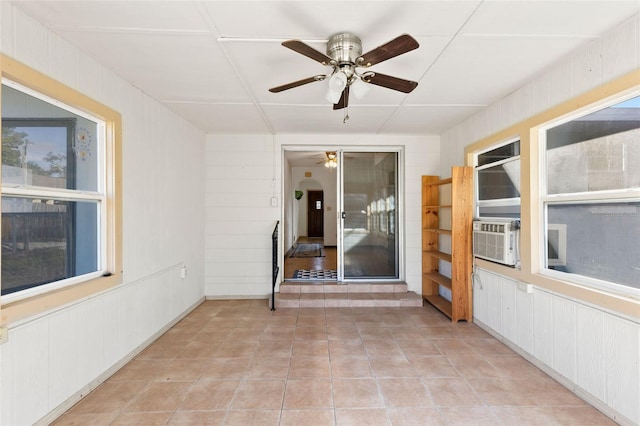 unfurnished sunroom with cooling unit and ceiling fan