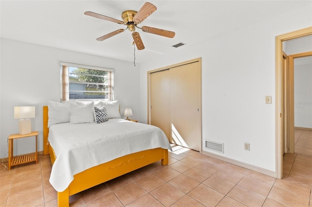 bedroom featuring a closet, ceiling fan, and light tile patterned flooring