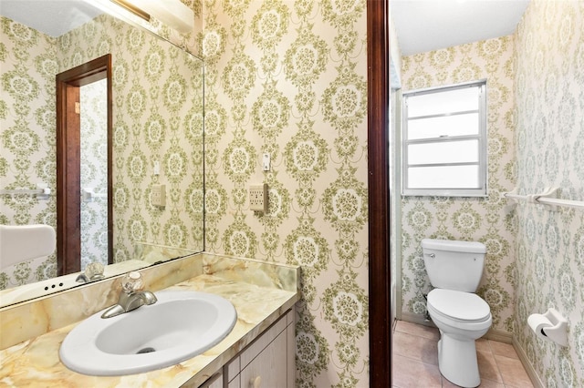 bathroom featuring vanity, tile patterned floors, and toilet