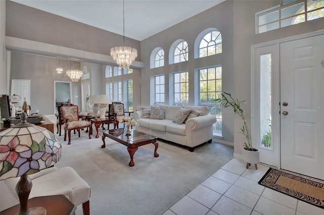 carpeted living room featuring a high ceiling and a notable chandelier