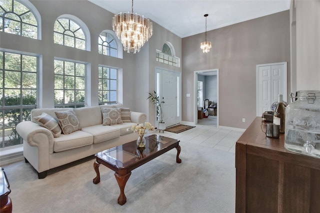 living room with light carpet, a towering ceiling, and a chandelier