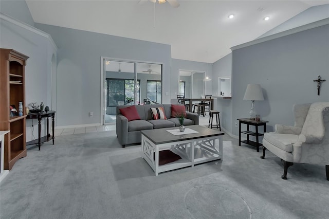 carpeted living room featuring ceiling fan and vaulted ceiling