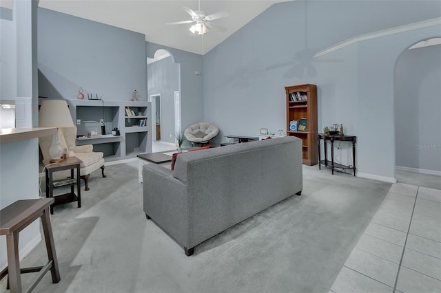 living room with ceiling fan, light tile patterned floors, and high vaulted ceiling