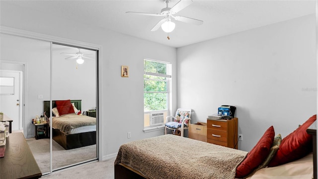 bedroom featuring cooling unit, ceiling fan, light colored carpet, and a closet