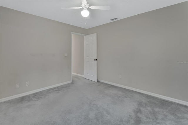 spare room featuring light carpet and ceiling fan