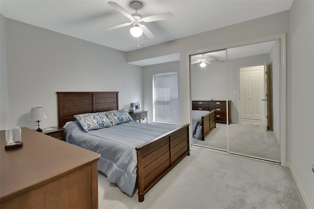 carpeted bedroom with a closet and ceiling fan