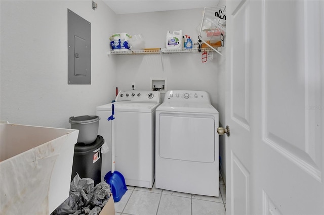 laundry area with light tile patterned floors, sink, electric panel, and washer and dryer