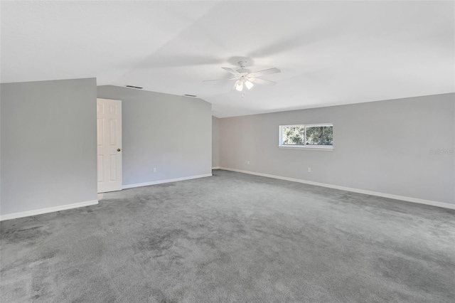 spare room featuring ceiling fan, lofted ceiling, and carpet