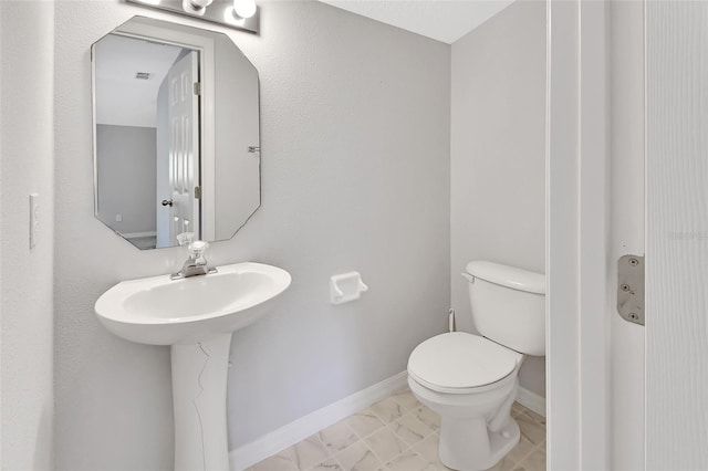 bathroom with tile patterned flooring and toilet