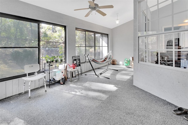 sunroom / solarium featuring ceiling fan and lofted ceiling