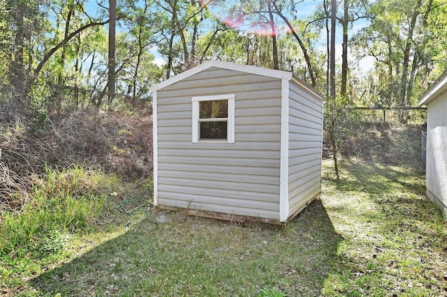 view of outbuilding featuring a lawn