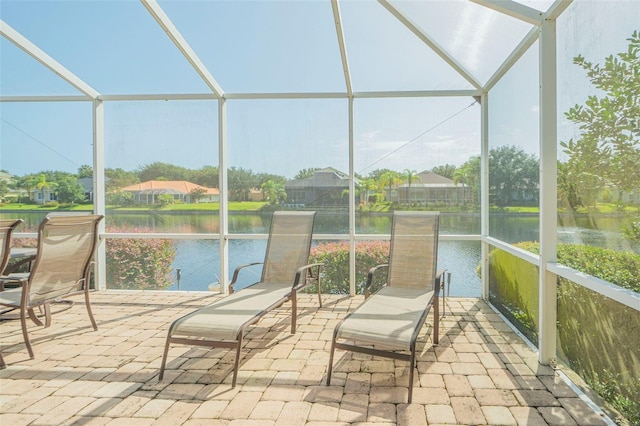 sunroom / solarium featuring a water view