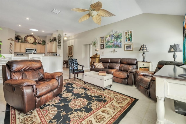 tiled living room featuring ceiling fan and vaulted ceiling