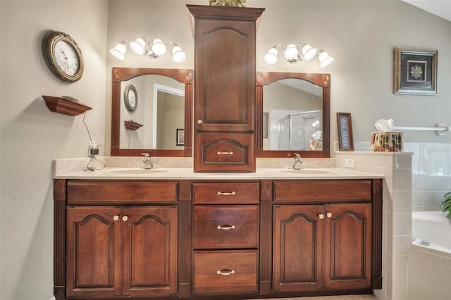 bathroom with vanity and shower with separate bathtub