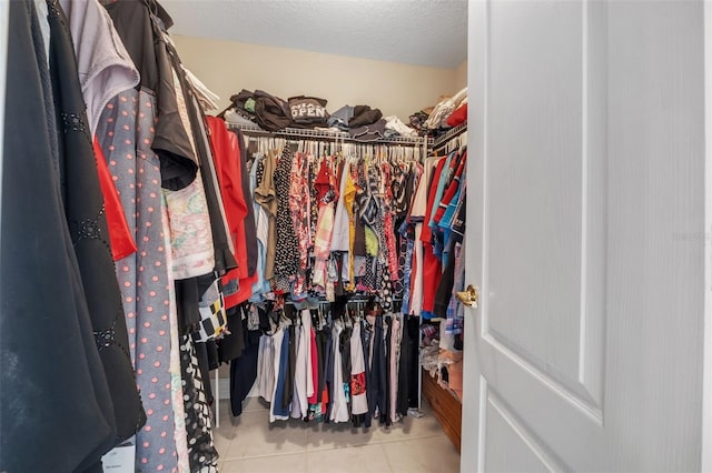 spacious closet with light tile patterned floors