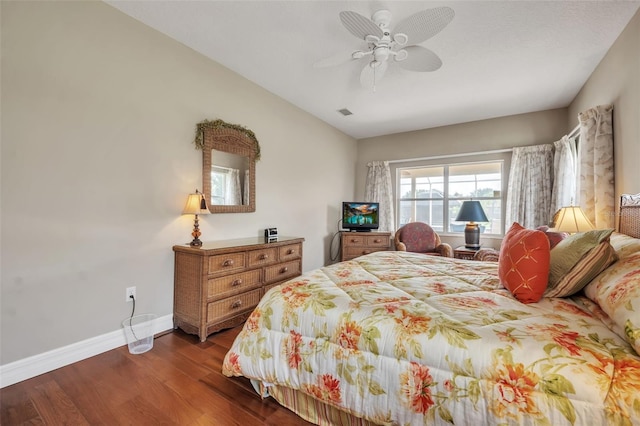 bedroom with dark hardwood / wood-style flooring and ceiling fan