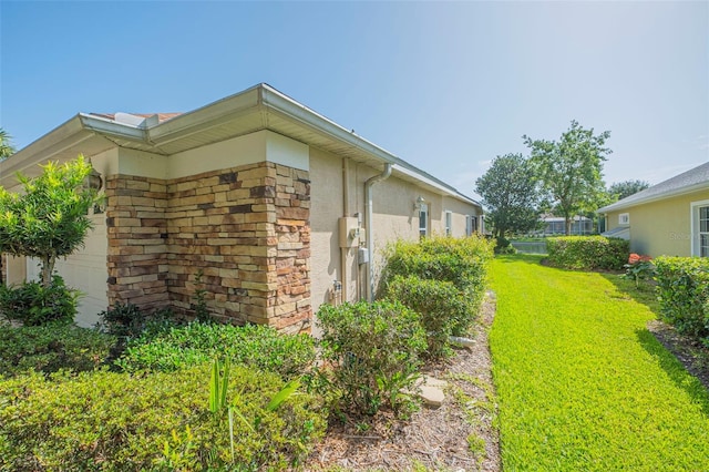 view of side of home with a lawn