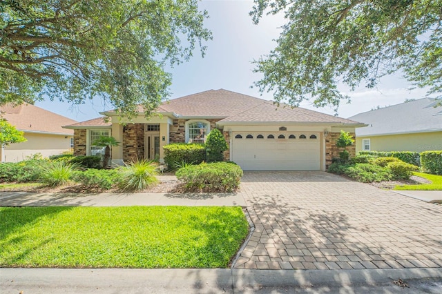 ranch-style home with a garage and a front yard