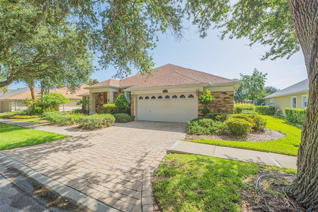 view of front of home featuring a garage and a front lawn