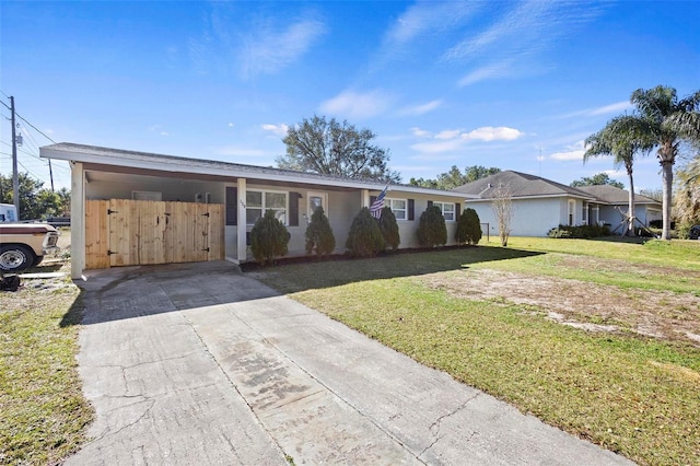 ranch-style house featuring a carport and a front yard