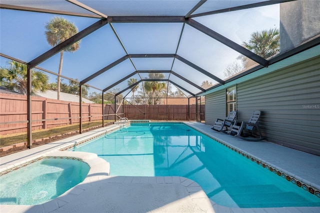 view of pool with a patio area and glass enclosure