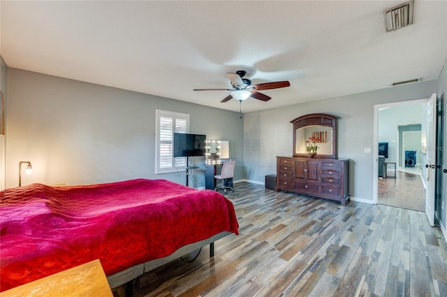 bedroom with ceiling fan and wood-type flooring