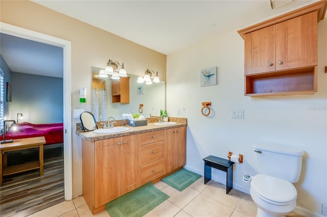 bathroom featuring vanity, toilet, and tile patterned flooring