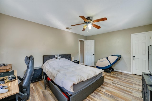 bedroom with ceiling fan and light hardwood / wood-style floors