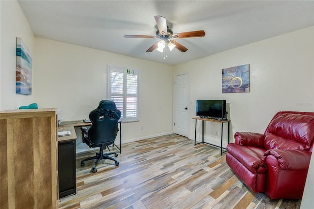 office space with ceiling fan and light wood-type flooring