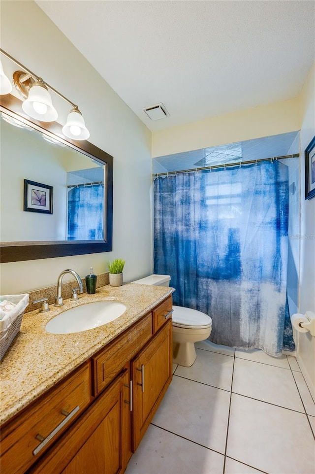 bathroom with vanity, tile patterned floors, and toilet