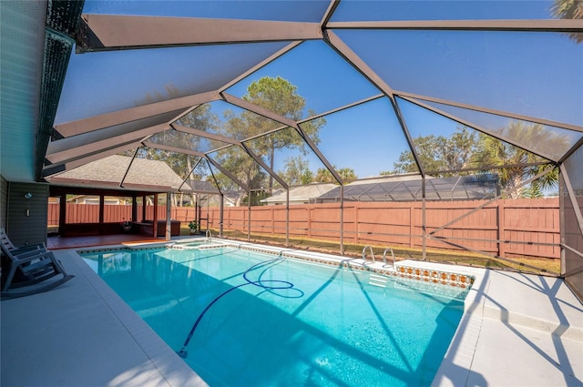 view of swimming pool featuring a lanai and a patio