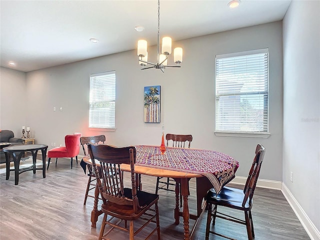 dining room featuring hardwood / wood-style flooring and a chandelier