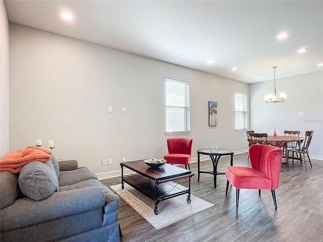 living room with a notable chandelier and dark hardwood / wood-style flooring