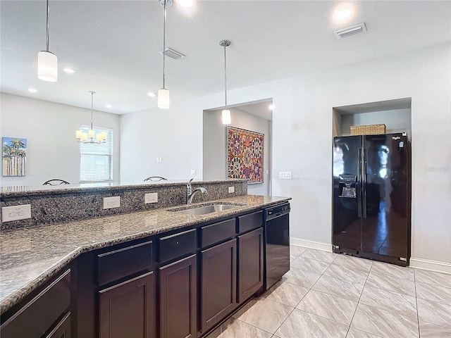 kitchen featuring dark brown cabinets, sink, pendant lighting, and black appliances