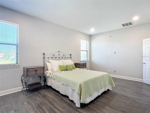 bedroom with dark hardwood / wood-style floors