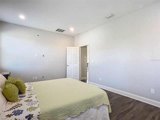 bedroom with dark hardwood / wood-style floors