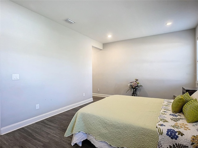 bedroom with dark hardwood / wood-style flooring