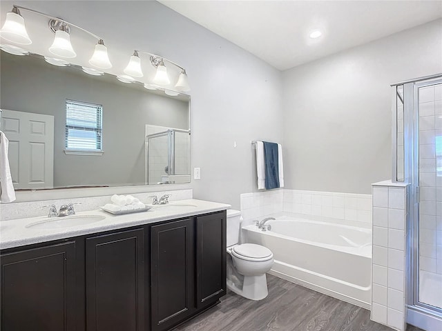 full bathroom featuring hardwood / wood-style flooring, vanity, plus walk in shower, and toilet