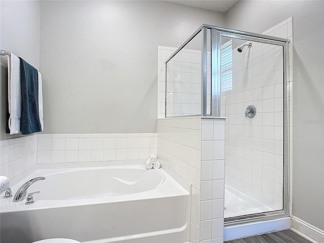 bathroom featuring shower with separate bathtub