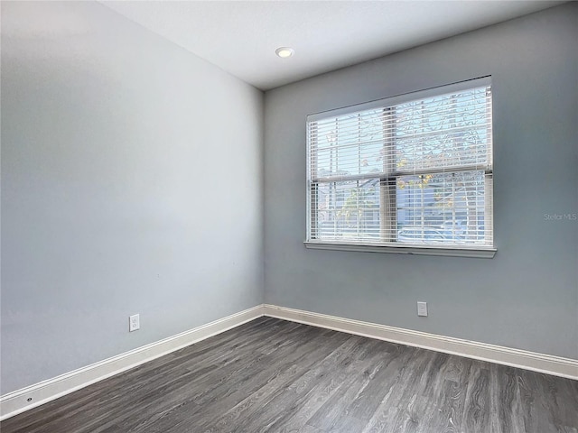 unfurnished room with dark wood-type flooring