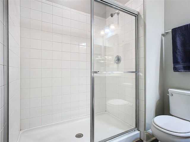 bathroom with walk in shower and toilet