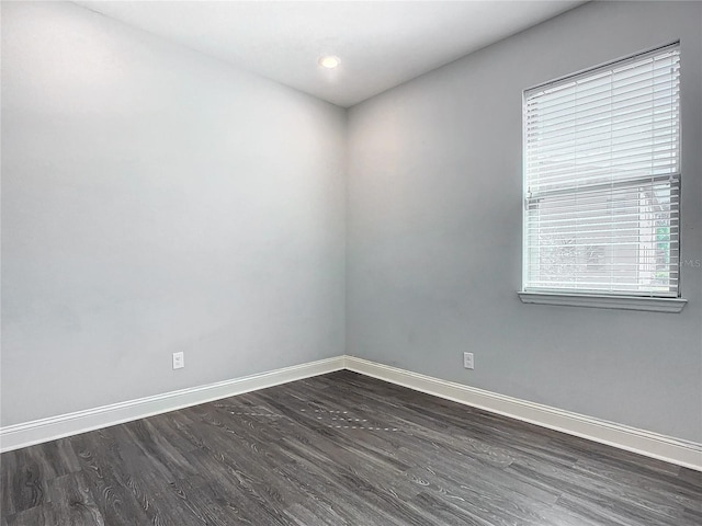 empty room with dark hardwood / wood-style floors